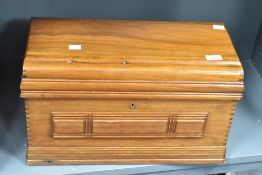 An early 20th century mahogany sewing machine box, of rectangular form with moulded decoration and