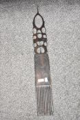 A early / mid 20th century hand-carved African hair comb, L75cm