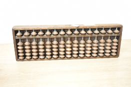 A Chinese wooden Abacus having calligraphy to reverse, h33cm