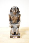 A figure of an Egyptian pharaoh having impressed symbols to back, h23.5cm