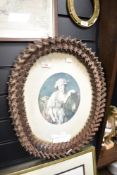 A late 19th/early 20th century 'Tramp Art' oval picture frame, intricately constructed out of