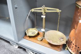 A Victorian brass balance scale on wooden base, on wooden base