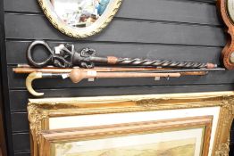 An African wooden walking stick having carved elephants, L89cm sold together with 4 other canes