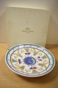 A large decorative Poole Pottery charger, of dished circular form decorated with repeating