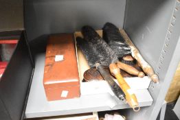 A group of cleaning brushes and an Oriental laquered box