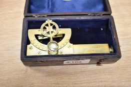 A brass level and clinometer with original case, stamped to side J.Motion & Co, Singapore, L10cm