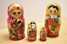 A group of four Russian Matryoshka nesting dolls, largest 22.5cm high