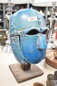 An early 20th century ceramic reproduction Angelo Saxon helmet having suspended parts in a blue