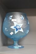 A large decorative oversized blue brandy style glass with painted floral decoration 29cm