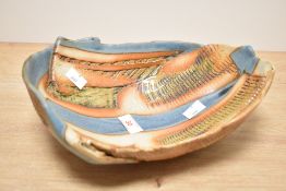 A studio pottery dish of oval form having orange and blue glaze, L28cm