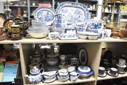 A large selection of vintage and modern Willow pattern blue and white wares