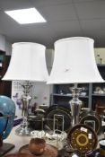 A pair of modern metallic table lamps, measuring 69cm respectively, shades included.