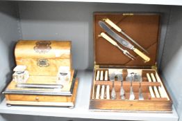 A Victorian walnut desk stand, having a raised and lidded superstructure with applied metal