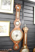 A late 19th century banjo barometer having convex mirror, temperature gauge and decorated with