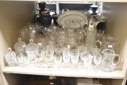A large selection of crystal and other cut and etched glass drinking glasses, claret jug, bon bon