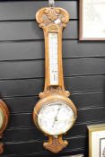 A early 20th century oak barometer having temperature gauge, h85cm