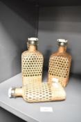 A pair of glass and wicker bottles, h19cm, sold together with 1 similar bottle