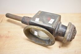 An early 20th century carriage oil lamp having red glass eye, h44cm