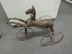 Victorian Wooden and cast metal Tricycle modelled as a horse on metal frame and wheels, straight