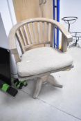 A reproduction swivel captains style chair in limed oak style finish
