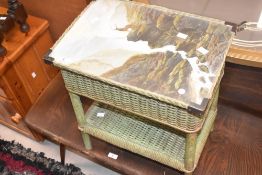 A mid century green woven wicker sewing box, the hinged lift-up top with Monarch of the Glen