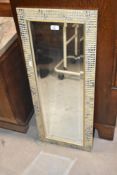 A modern mosaic effect wall mirror, approx. 85 x 34cm