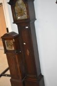 An early 20th Century oak cased Grandmother style long case clock having Roman numeral dial,
