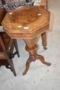 A Victorian walnut sewing box having octagonal top and fitted interior on triple splay legs