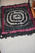 A traditional pegged/proddy rag rug, approx 95 x 86cm