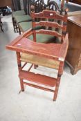 A Victorian childs high chair having painted Romany style decoration