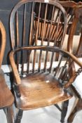A traditional Windsor style chair in the vernacular style, having turned leg and H stretcher , width