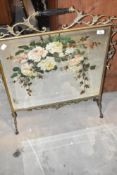 A vintage painted fire screen