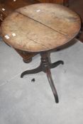 A 19th century oak pedestal occasional table, the circular top above the turned urn form column