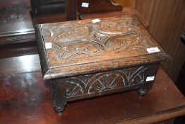A carved oak lidded storage box of small proportions, width approx. 36cm