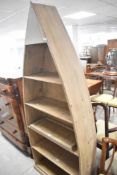 A modern stained frame 'boat' bookcase, height approx. 205cm