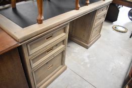 A modern stained frame desk having inset top and campaign style handles, width approx. 174cm