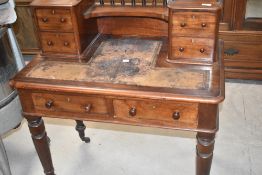 A Victorian mahogany desk having spindle back to shelf and two double drawer sections, width approx.