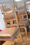 A set of four late 19th or early 20th Century Arts & Crafts oak dining chairs having shaped back