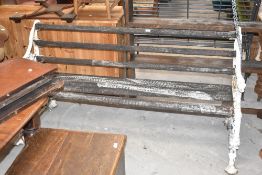 A Victorian cast-iron garden bench, the cast-iron ends with coiled serpent and fruiting vine