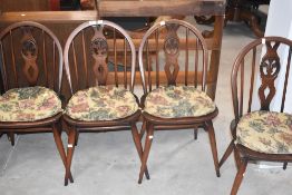 A set of four Ercol Fleur dis Lis backed dining chairs, seat height 42cm