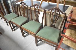 A set of four early 20th Century mahogany framed dining chairs having wheat sheaf style splat