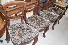 A set of four Victorian mahogany railback dining chairs having vintage moquette style floral seats