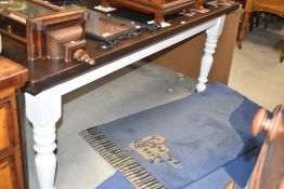 A stained and painted pine farmhouse style kitchen table, of rectangular form with turned legs