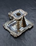 A George IV silver chamberstick, of traditional form having a rectangular sconce with a floral