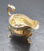 A George III silver gravy boat, having an egg and dart style rim, a narrow spout opposed by a scroll