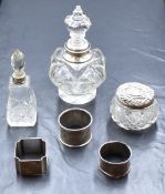 An Edwardian silver mounted glass scent bottle, of decorative lobed form with moulded finial top,