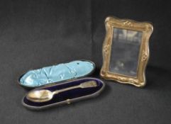 An Elizabeth II silver mounted photograph frame, of lobed rectangular form having ribbon decoration,