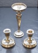 A pair of Elizabeth II silver candlesticks, of traditional squat form having moulded sconces, raised