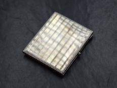 A George V silver cigarette case, of hinged rectangular form, having engine turned and white
