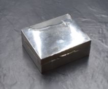 A 20th century silver cigarette box, of hinged rectangular form, having 'RWM' monogram to the lid